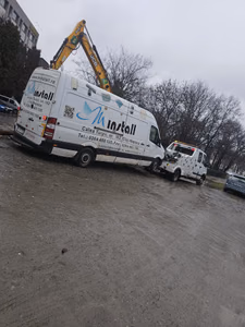 Zi cu ceață, lângă un excavator JCB. Dubă mare de marfă Mercedes Sprinter